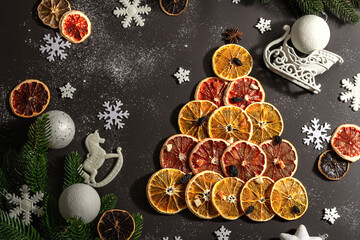 Obraz na płótnie Canvas Festive fir tree from dried fruits. Christmas or New Year festive flat lay, food creative