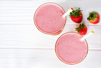 Strawberry yogurt fruit juice smoothie pink colorful fruit juice milkshake blend beverage healthy high protein the taste yummy In glass drink episode morning on white wood background from the top view