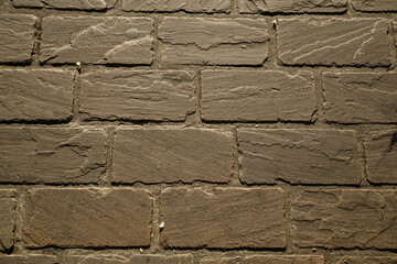 Brown brick wall on a street seamless texture. 