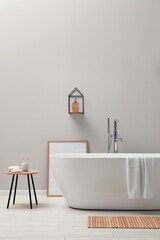 Fototapeta na wymiar Modern ceramic bathtub near light wall indoors