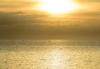 Beautiful sunset with glistening seas and romantic clouds. 