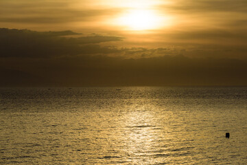 Beautiful sunset with glistening seas and romantic clouds. 