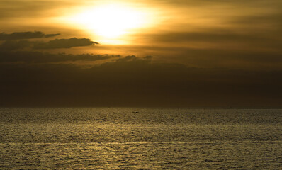 Beautiful sunset with glistening seas and romantic clouds. 