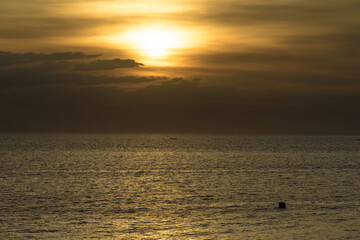 Beautiful sunset with glistening seas and romantic clouds. 