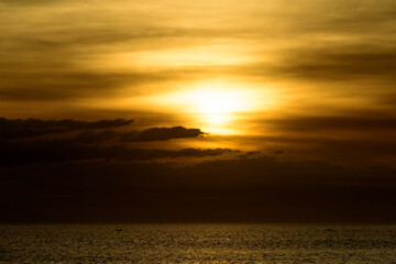 Beautiful sunset with glistening seas and romantic clouds. 
