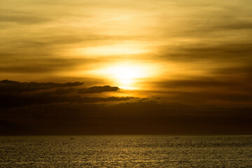 Fototapeta premium Beautiful sunset with glistening seas and romantic clouds. 