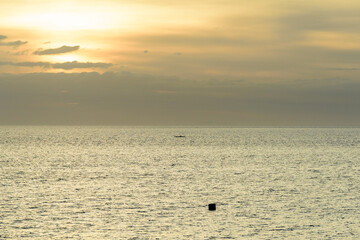 A gorgeous sunset over the Pacific Ocean with silhouette shots of fishing boats. 