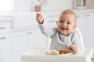 Cute little baby eating healthy food at home. Space for text - Powered by Adobe
