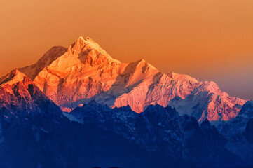 Beautiful first light from sunrise on Mount Kanchenjugha, Himalayan mountain range, Sikkim, India. Orange tint on the Himalayan mountains at dawn