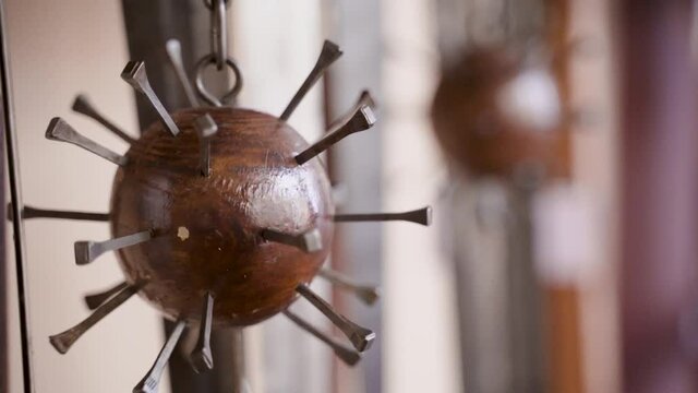 Old flail weapon, close up, handheld, panning with blurry background