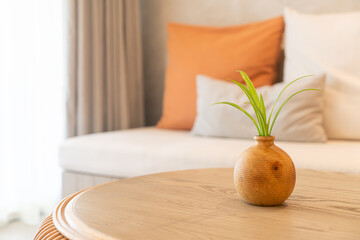 ceramic or porcelain vase with plant decoration on table in living room
