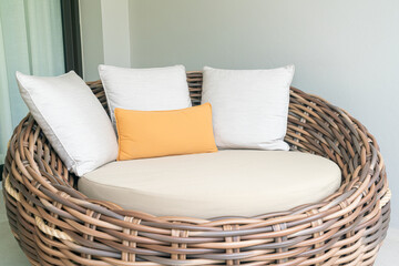 pillows on outdoor patio wicker sofa
