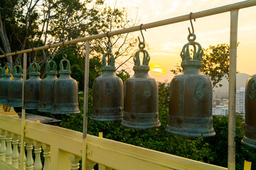 Fototapeta na wymiar metallic bells hanging in a row outside in thai buddhist temple