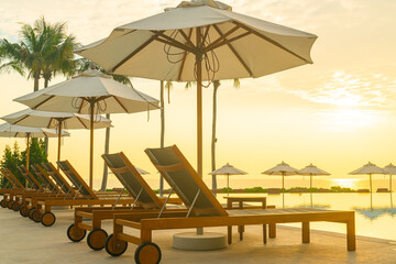 umbrella with bed pool around swimming pool with ocean sea background