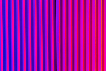 Pink and violet background with lines. Abstract neon background with gradient and stripes.