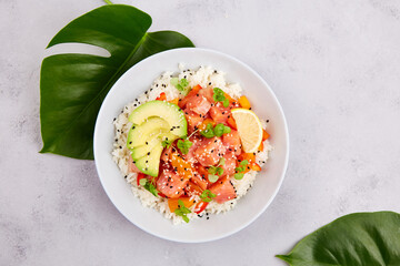 Poke bowl with salmon or tuna, rice, avocado, sesame seeds, micro greens. Hawaiian diet food with...