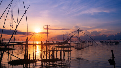 Sunrise with fishing trap in pak pra village Phatthalung Thailand Beautiful light sunrise or sunset sky in the nature