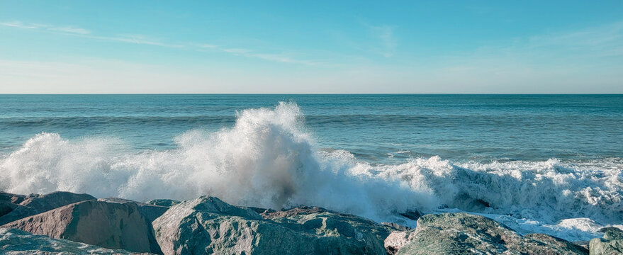 Seascape of the black sea beach. Sea waves crash and splash on rocks. View of the sea, ocean. Natural soft blue background. View of the sea, ocean. Batumi, Georgia