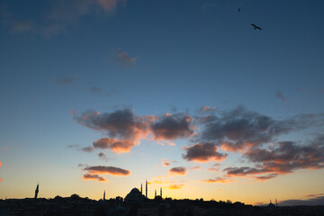 Ramadan background. Silhouette of cityscape of Istanbul at sunset with clouds.