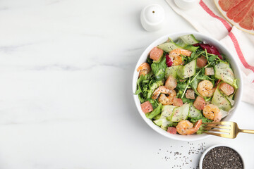 Delicious pomelo salad with shrimps served on white  table, flat lay. Space for text