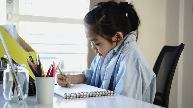 Little girl drawing intently