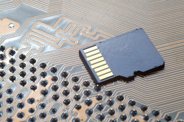 the black micro sd card lies on the microcircuit. close-up.