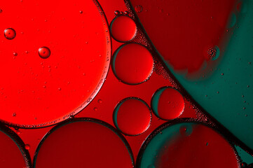 abstract background. drops of oil on water, red and green color. macro