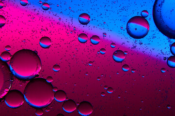 abstract background. drops of oil on water, blue and red. macro