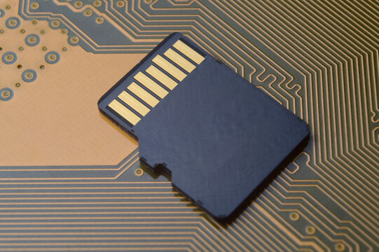 the black micro sd card lies on the microcircuit. close-up.
