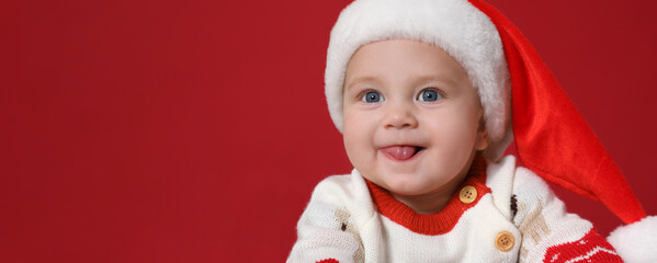 Cute baby wearing Santa hat on red background, banner design with space for text. Christmas celebration