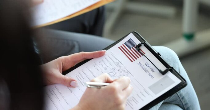 Group of people fills out American visa application form