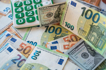 concept of exchange of dollars and euros with calculator