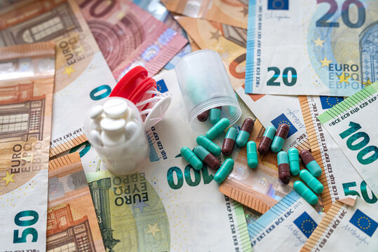 different capsules on pile of euro banknotes background