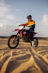 Man on sport motor over sand terrain