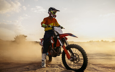 Fototapeta Motocross rider on sportmotor over dust landscape obraz