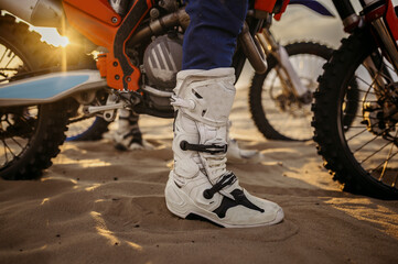 Motorcycle trials during motocross competition closeup rider boots
