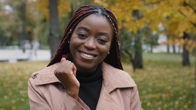 Beautiful happy successful african american woman smile looking at camera make send air kiss millennial girl posing outdoors farewell gesture, flirting demonstrating feelings and love see you concept