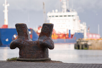 Obraz premium Closeup shot of rusty steel anchor and big ship in the background at Galway docks in Ireland 