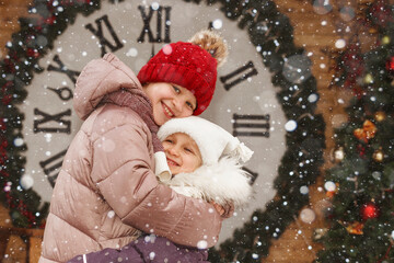 Happy New Year. Happy children  celebrate the new year. Festive kids in snow winter.