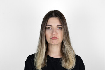 Naklejka premium young beautiful sad woman serious and concerned looking worried and thoughtful facial expression feeling depressed isolated white background in sadness and sorrow emotion