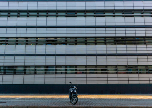 Lone motorcycle in front of office building