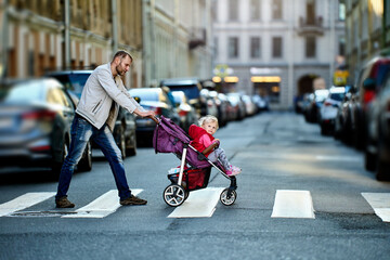 Father with daughter in buggy on street of St. Petersburg.