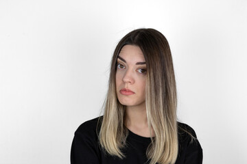 Young girl with serious and angry expression on her face. She is in anger. She asked something and...