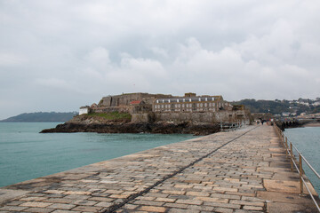 Fototapeta na wymiar Castle Cornet Guernsey from the harbour breakwater by the lighthouse