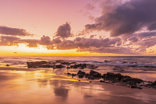 Sandy coastal beach at moody sunrise