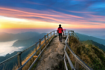 Fototapeta na wymiar Tourist walking on Phu chi dao mountain at sunrise in Chiang Rai province, Thailand.