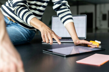 Businesswoman pointing at tablet PC on office desk