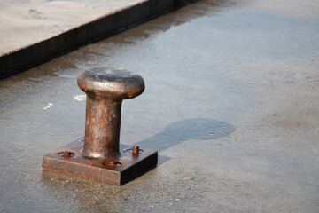 Bollards for mooring boats at the quay... Quay bollard and rope detail