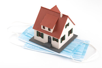 Mask and house model on white background