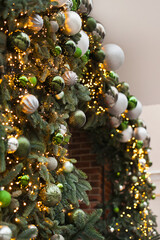 christmas garlands with green and silver color decorations and lights as festive holiday season store decor